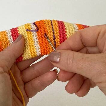 Picture Fig 20 - using needle to pull knot inside piece