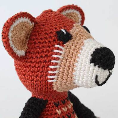 Crochet Red Panda - picture showing embroidered details on sides of face.